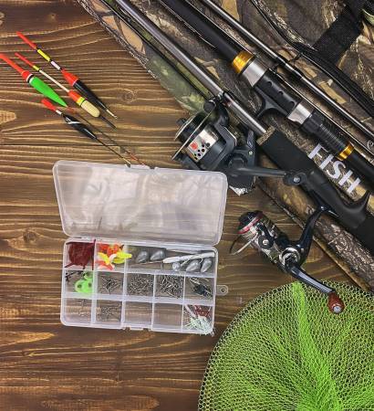 Fishing tackle. Float, wobbler, bait hooks, on a wooden background. Selective focus